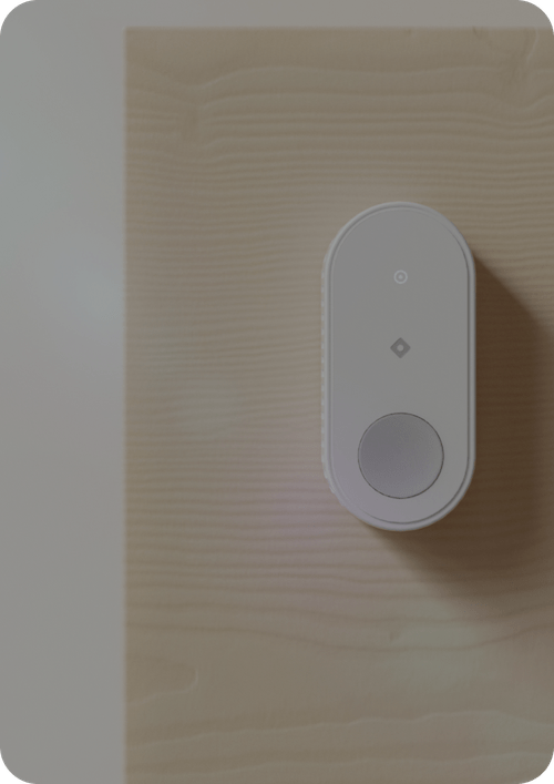 Rhombus IoT sensor B10 button installed on a wall, showcasing its role as a smart IoT security device in connected environments. Enable one-touch emergency response with this programmable button.