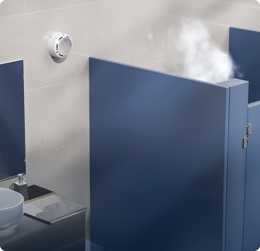 A rhombus-shaped environmental sensor installed inside a restroom, designed for monitoring air quality and detecting vape. This connected device features humidity sensors and monitors temperature, providing accurate data on ambient temperature and relative humidity.