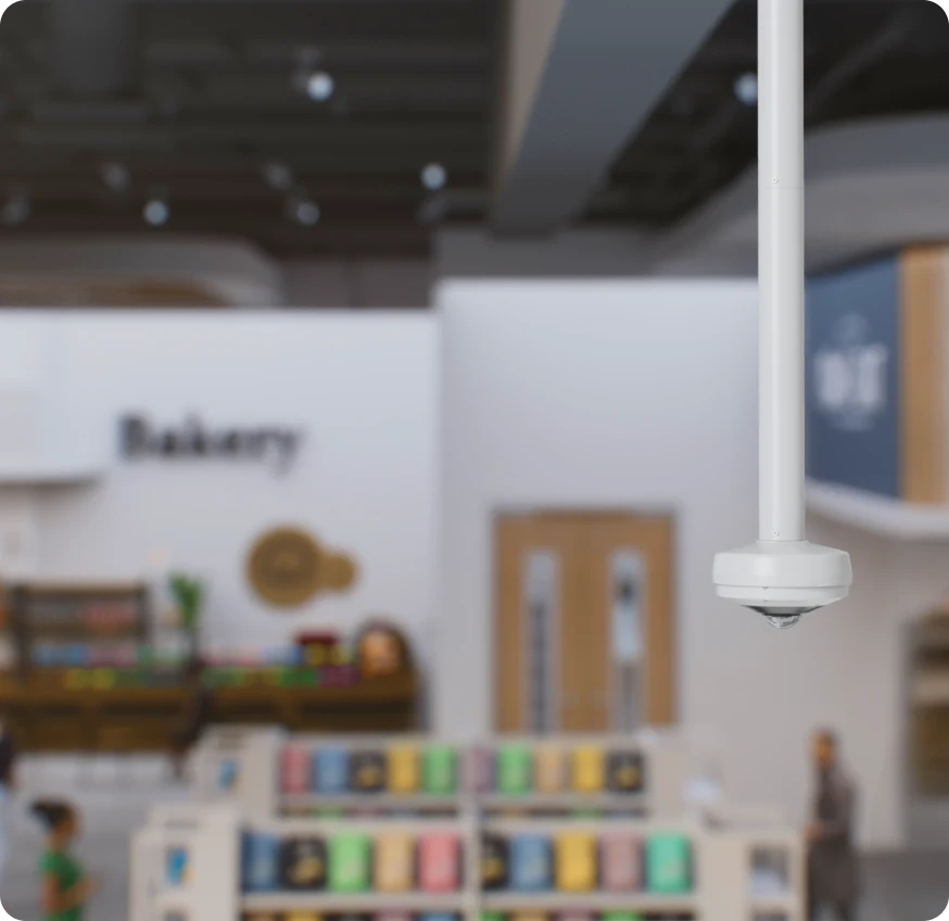 Rhombus fisheye camera with advanced features installed indoors at a workplace, eliminating the need for multiple progressive scan cameras.