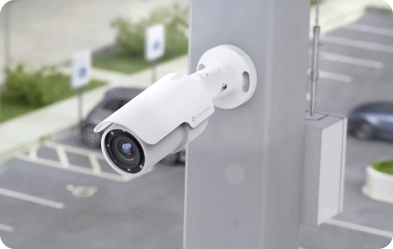 a Rhombus bullet camera mounted in a parking lot