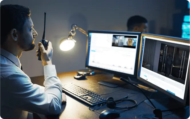 A man monitors his screen to provides professional monitoring and assess security threats in real-time using the Rhombus business security system