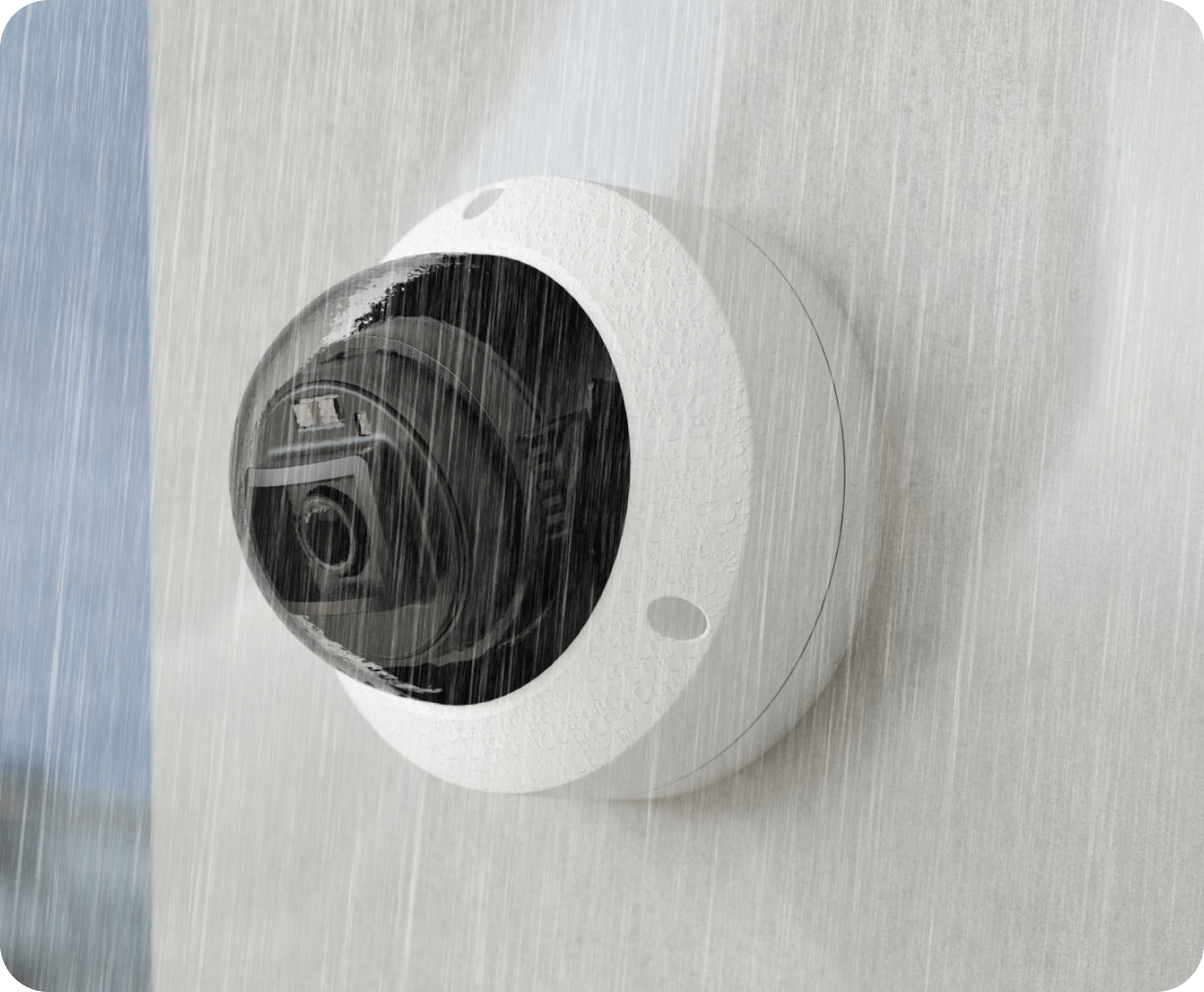Dome security camera mounted on a wall, monitoring in all weather conditions